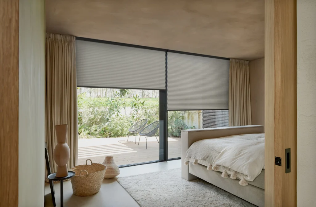 Honeycomb blinds in a bedroom.